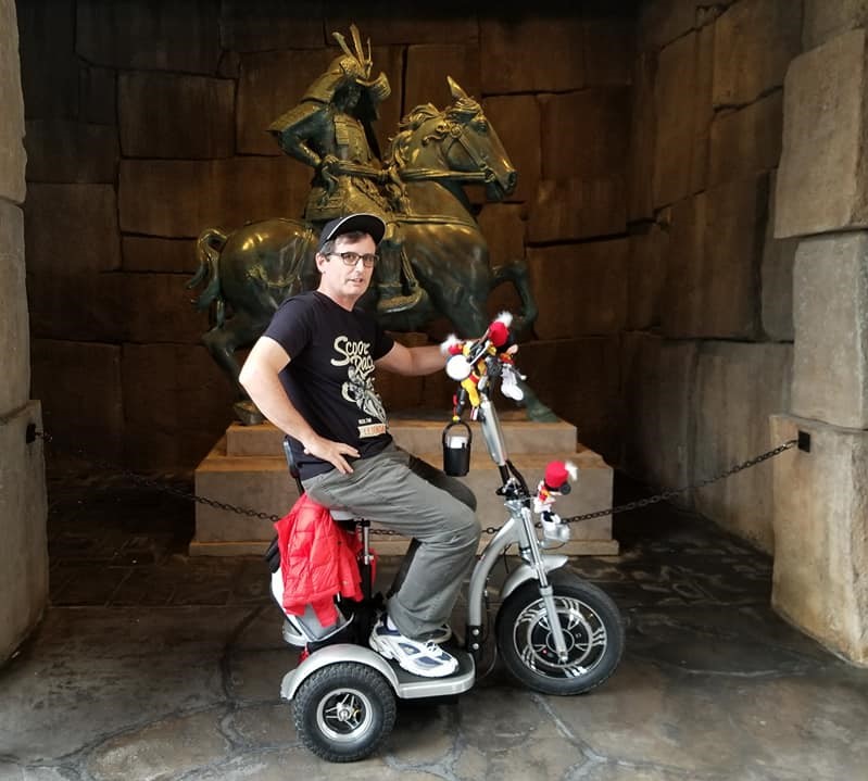 Tired Husband on a scooter at Epcot