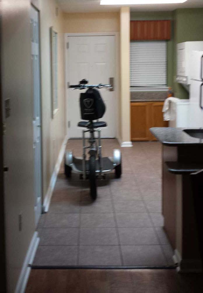A scooter fits in the kitchen